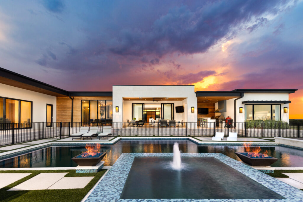 Exterior setting with pool, fountain, modern architecture